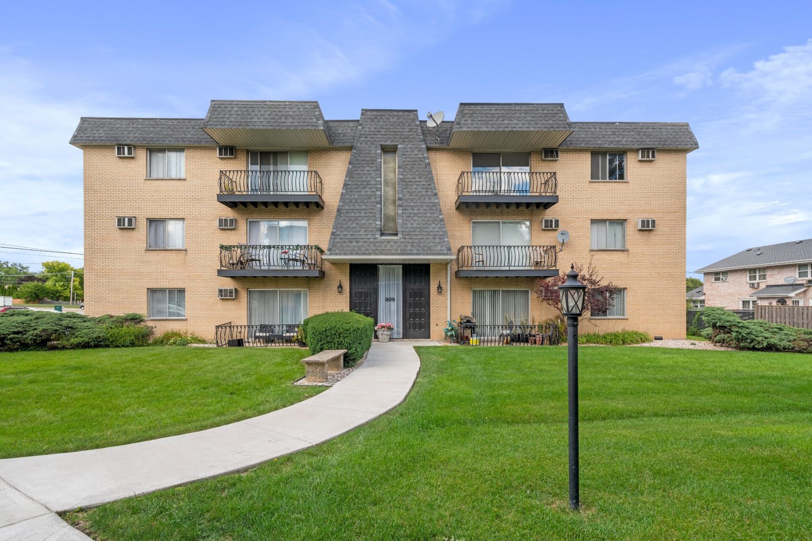 909 Plainfield Road, Unit 12 Darien, IL 60561 - Photo 1 of 10 a view of a big building with a big yard and large trees