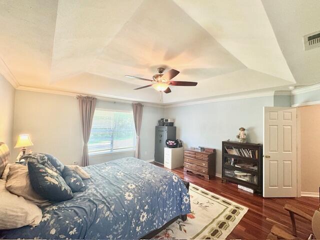 4258 Shadow Lane Niceville, FL 32578 - Photo 20 of 35 a bedroom with a bed and a bookshelf with wooden floor