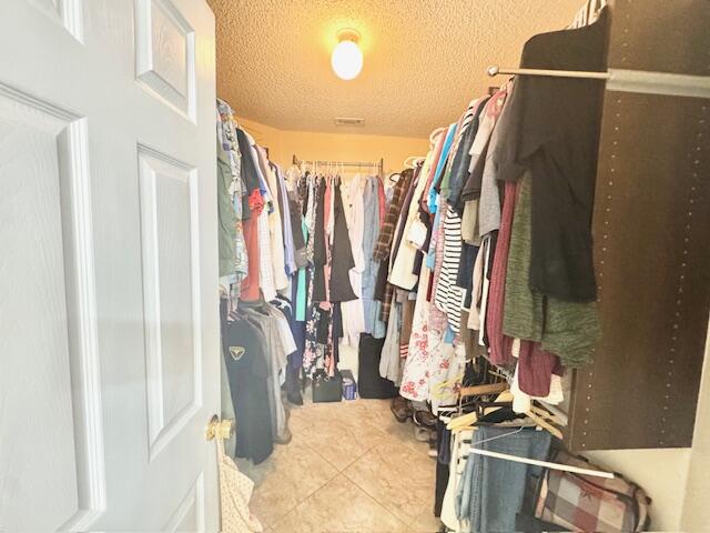 4258 Shadow Lane Niceville, FL 32578 - Photo 21 of 35 a view of walk in closet with clothes