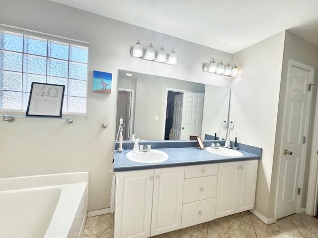 4258 Shadow Lane Niceville, FL 32578 - Photo 23 of 35 a bathroom with a double vanity sink a mirror a and a bathtub