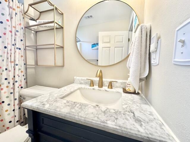 4258 Shadow Lane Niceville, FL 32578 - Photo 28 of 35 a bathroom with a granite countertop sink a mirror and vanity