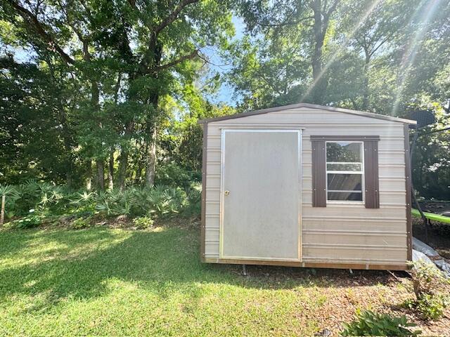 4258 Shadow Lane Niceville, FL 32578 - Photo 33 of 35 a front view of a house with a garden