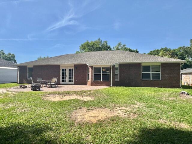 4258 Shadow Lane Niceville, FL 32578 - Photo 35 of 35 a view of a house with backyard sitting area and garden