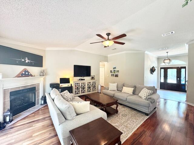 4258 Shadow Lane Niceville, FL 32578 - Photo 9 of 35 a living room with furniture a fireplace and a flat screen tv