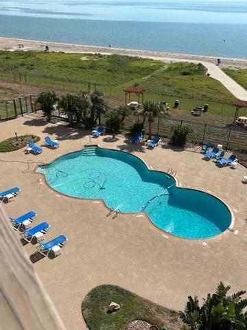 a view of a swimming pool with outdoor seating