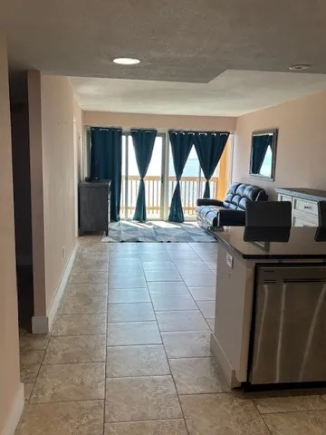 a bathroom with a granite countertop bathtub shower and toilet