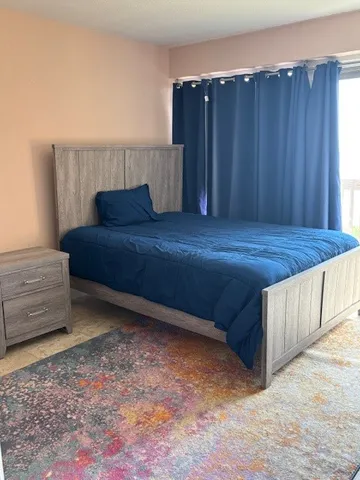 a bedroom with a bed and a window