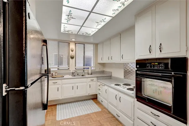 a kitchen with stainless steel appliances granite countertop a stove sink and cabinets
