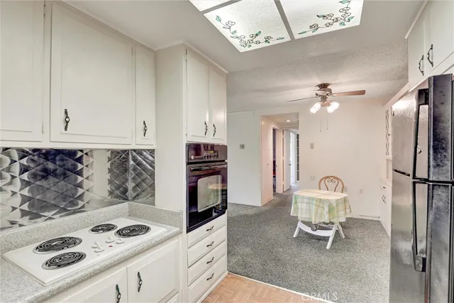 a kitchen with stainless steel appliances granite countertop a cabinets a stove a sink and a refrigerator