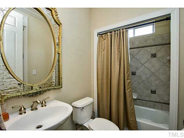 10001 Hidden Vale Drive Raleigh, NC 27614 - Photo 15 of 24 a bathroom with a sink and a mirror
