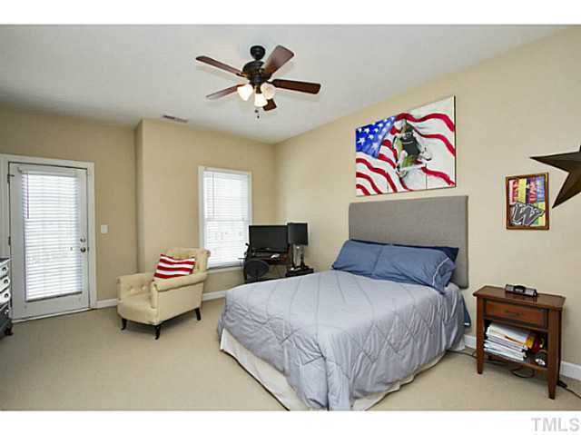10001 Hidden Vale Drive Raleigh, NC 27614 - Photo 20 of 24 a bedroom with a bed and a chandelier