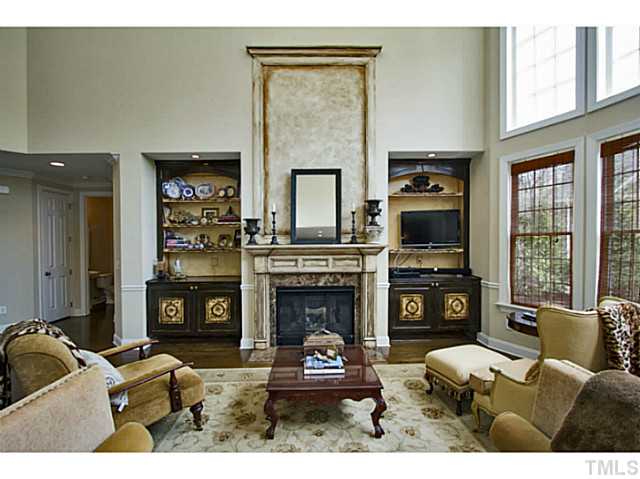 10001 Hidden Vale Drive Raleigh, NC 27614 - Photo 10 of 24 a living room with furniture a fireplace and a flat screen tv