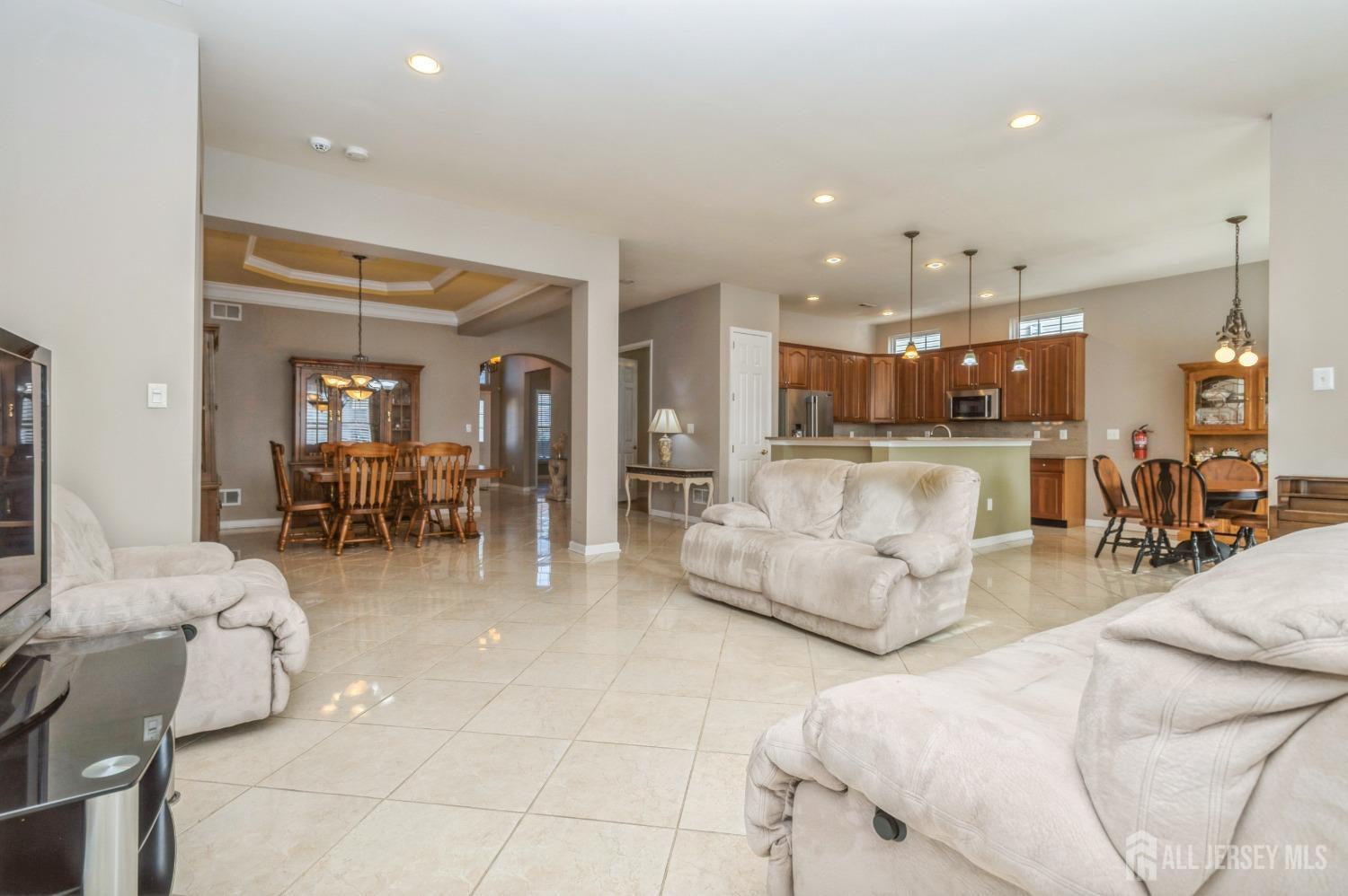 82 Beth Page Drive Monroe Township, NJ 08831 - Photo 12 of 40 a living room with furniture and a view of kitchen