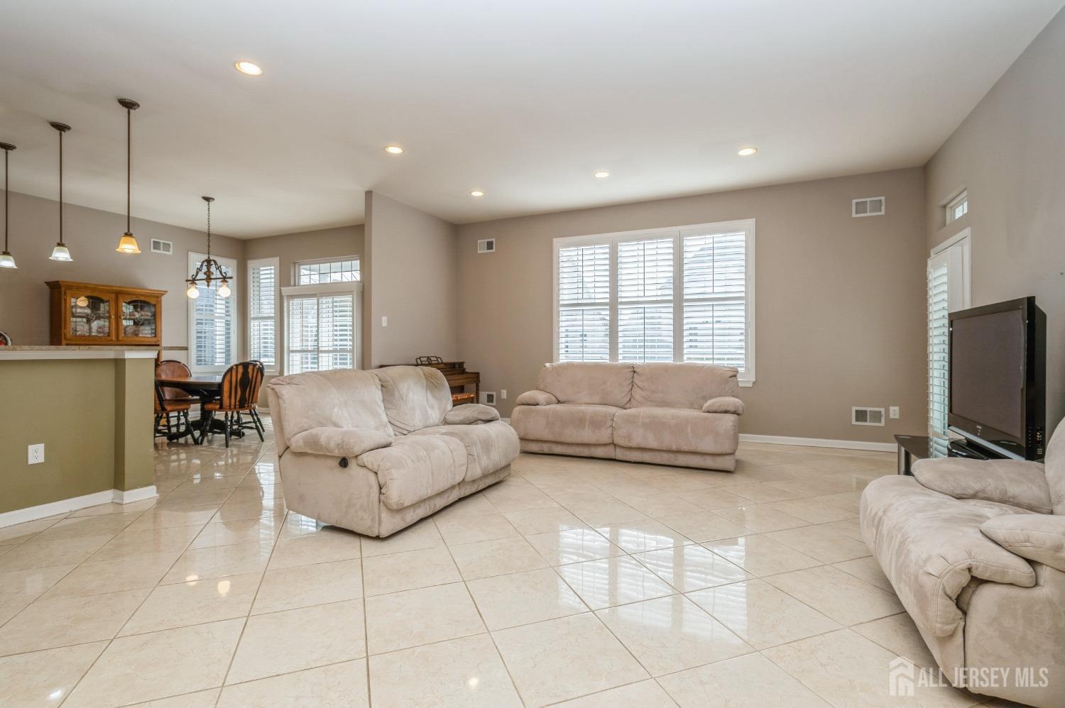 82 Beth Page Drive Monroe Township, NJ 08831 - Photo 13 of 40 a living room with furniture and a flat screen tv