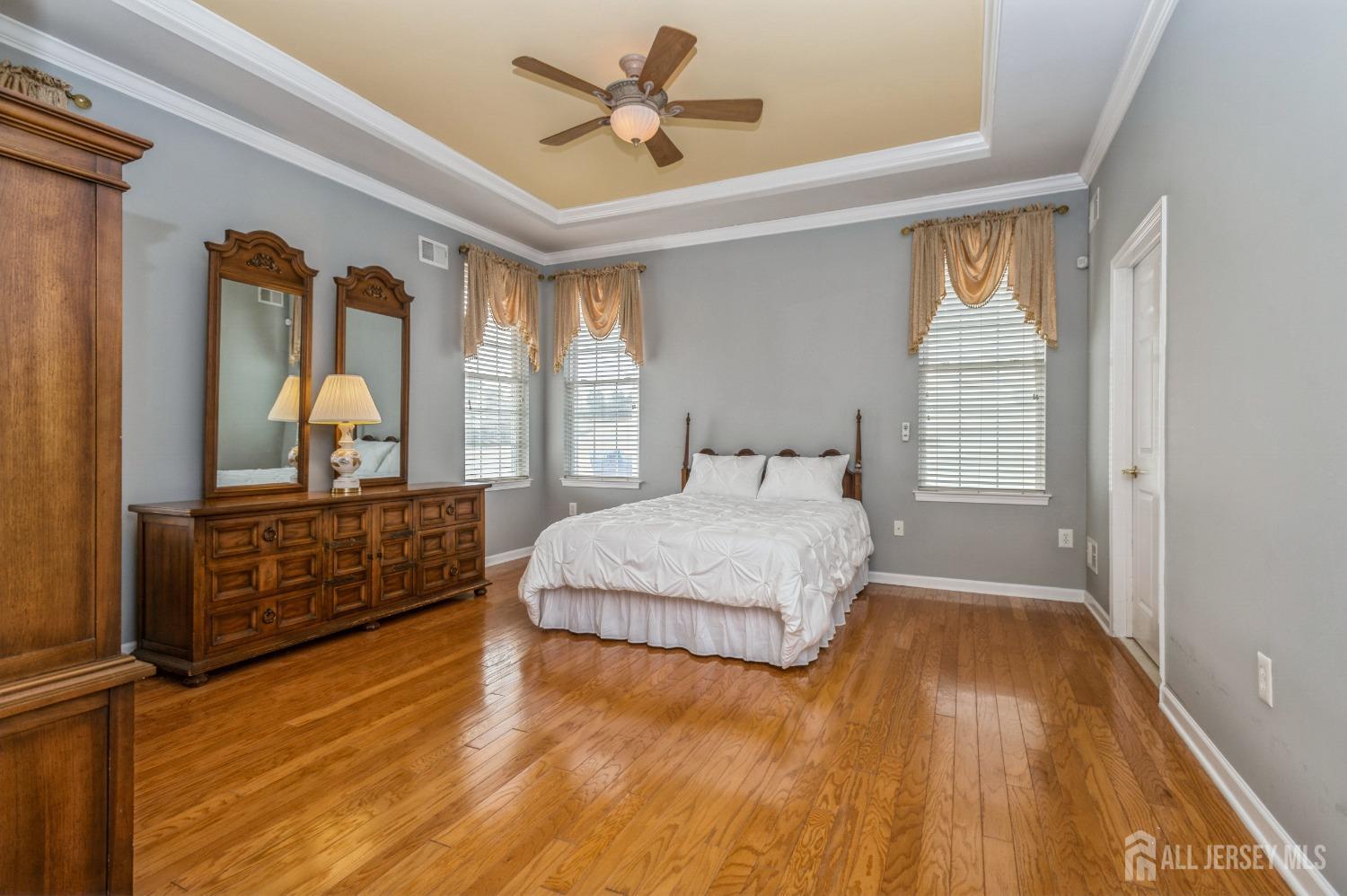 82 Beth Page Drive Monroe Township, NJ 08831 - Photo 15 of 40 a bedroom with a large bed and wooden floor