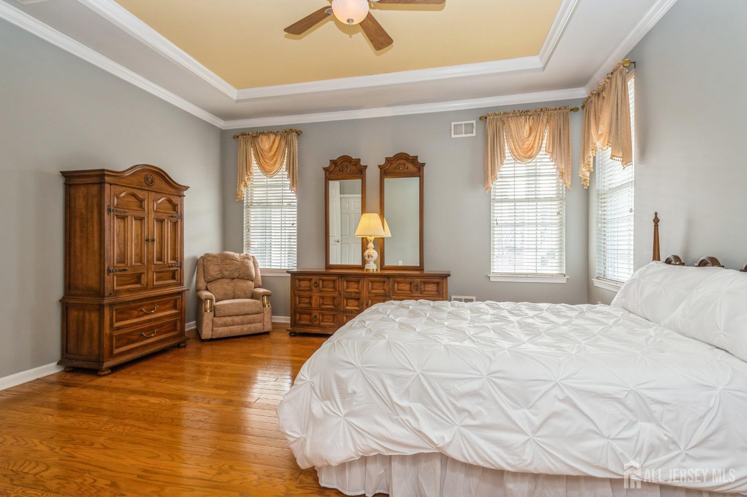 82 Beth Page Drive Monroe Township, NJ 08831 - Photo 17 of 40 a bedroom with a bed and wooden floor