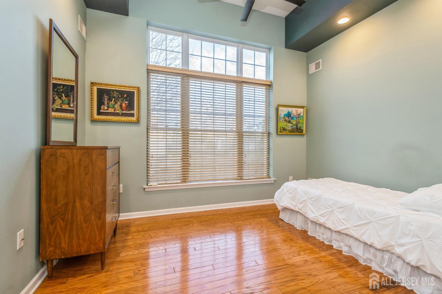 82 Beth Page Drive Monroe Township, NJ 08831 - Photo 19 of 40 a bedroom with a bed and wooden floor