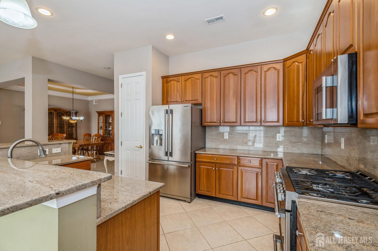 82 Beth Page Drive Monroe Township, NJ 08831 - Photo 4 of 40 a kitchen with stainless steel appliances granite countertop a sink stove and refrigerator