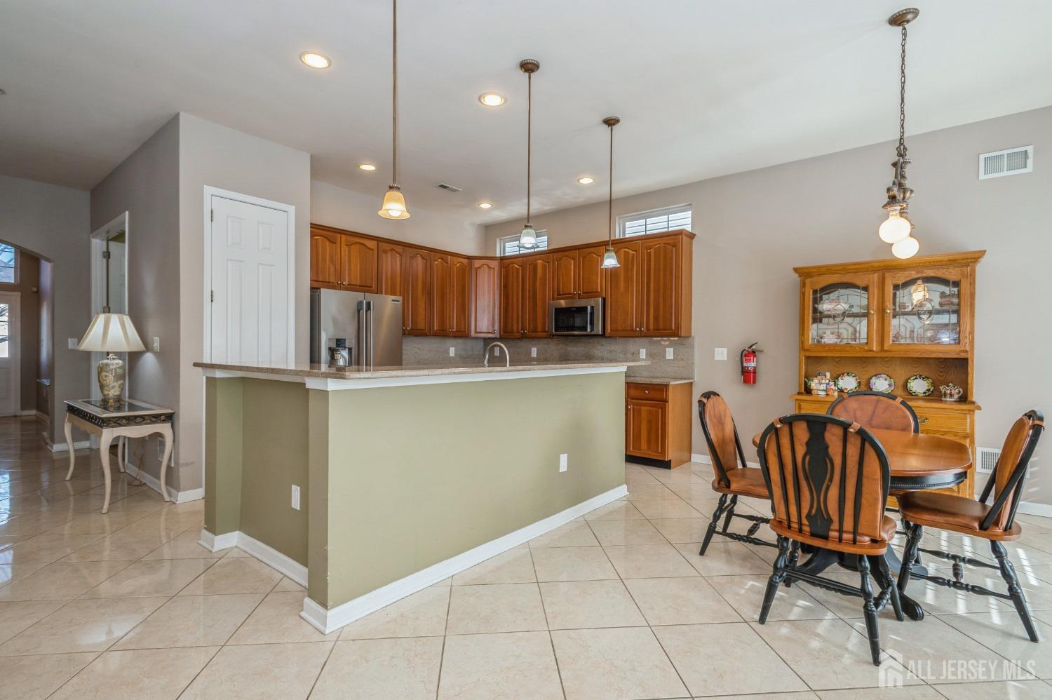 82 Beth Page Drive Monroe Township, NJ 08831 - Photo 7 of 40 a kitchen with cabinets and chairs