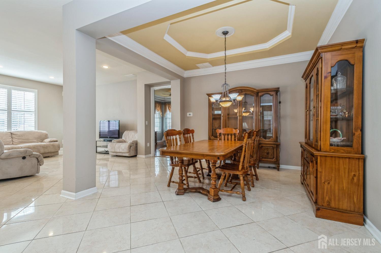 82 Beth Page Drive Monroe Township, NJ 08831 - Photo 9 of 40 a view of a dining room with furniture and chandelier