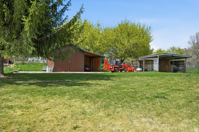 45 West 100 South Mendon, UT 84325 - Photo 46 of 64 View of green lawn featuring a pole building and an outdoor structure