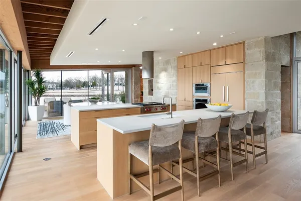 a large kitchen with a table and chairs