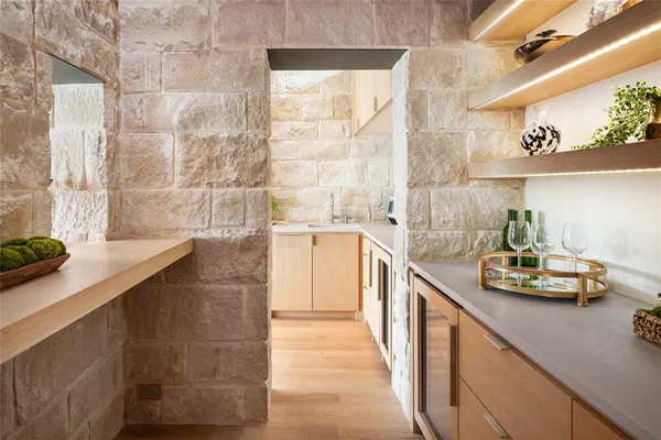 a kitchen with a sink and a stove next to a window