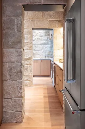 a bathroom with a large window a bathtub and shower