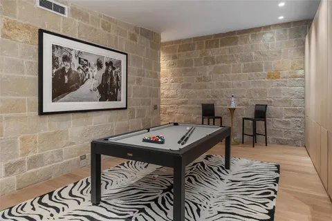 a bedroom with bed and large windows