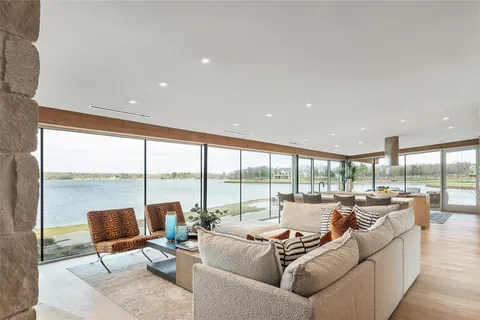 a living room with furniture fireplace and a large window