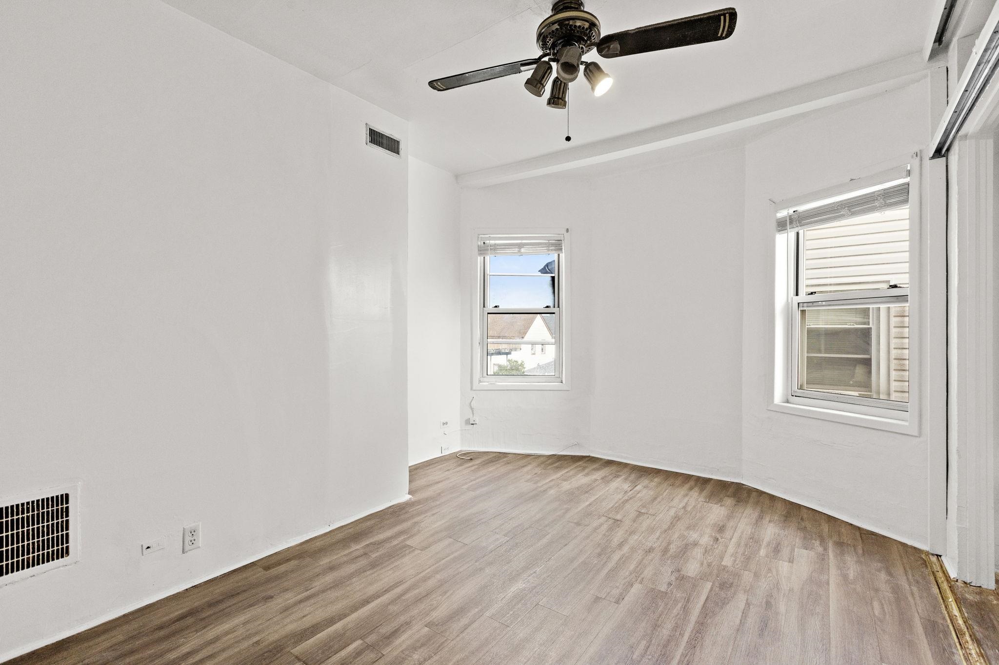 43 West 43rd Street Bayonne, NJ 07002 - Photo 11 of 22 a view of empty room with wooden floor and fan