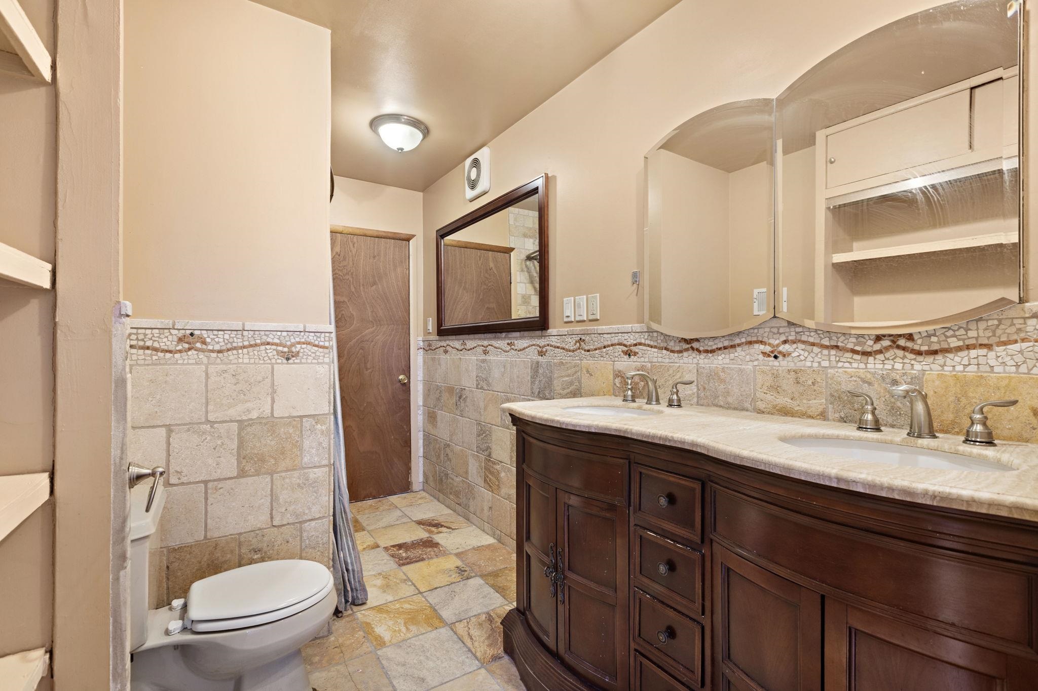 43 West 43rd Street Bayonne, NJ 07002 - Photo 12 of 22 a bathroom with a granite countertop sink toilet and shower