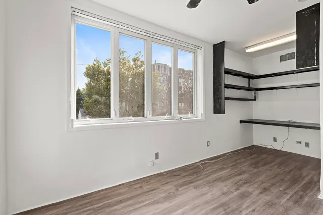 a view of a room with wooden floor and windows