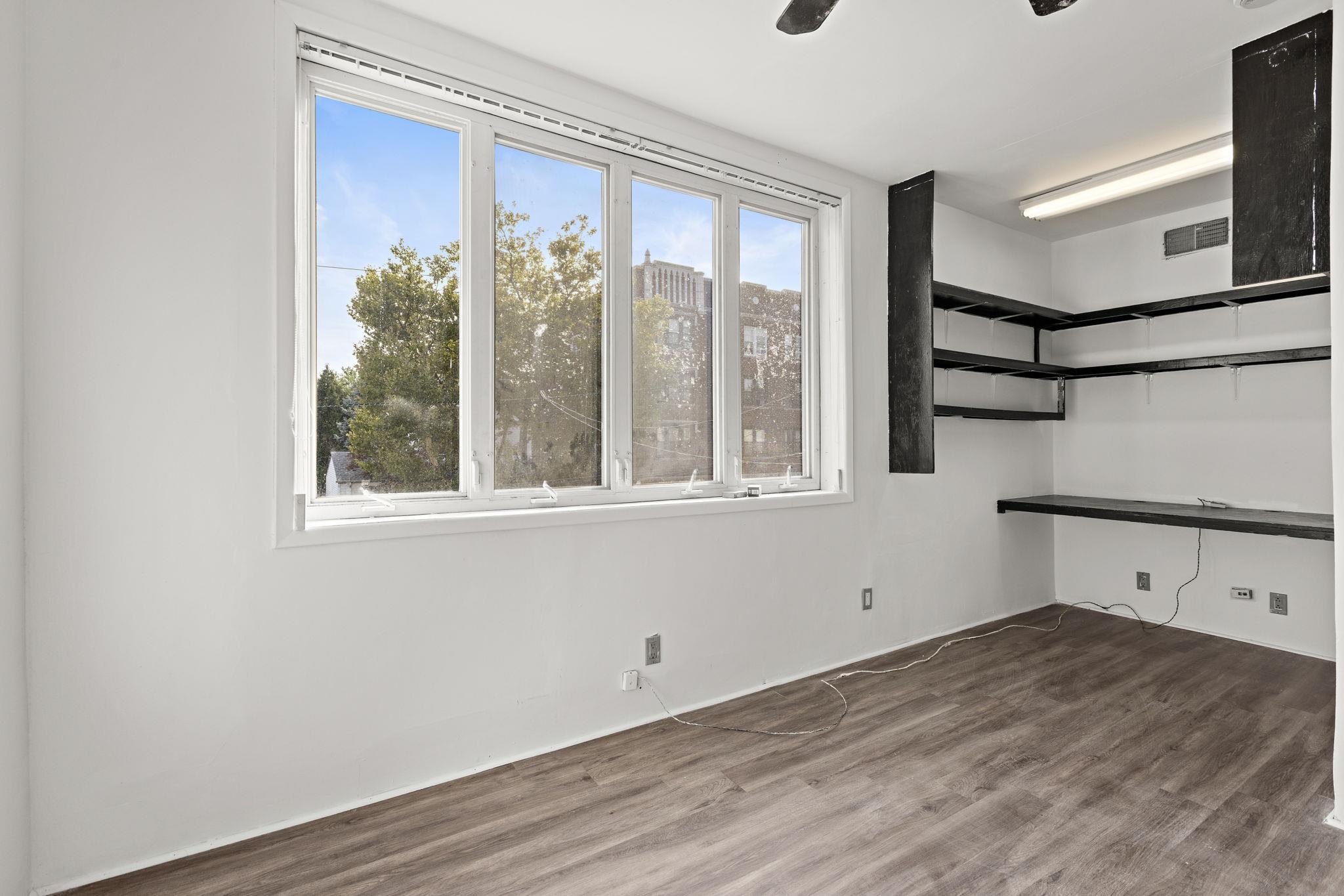 43 West 43rd Street Bayonne, NJ 07002 - Photo 14 of 22 a view of a room with wooden floor and windows