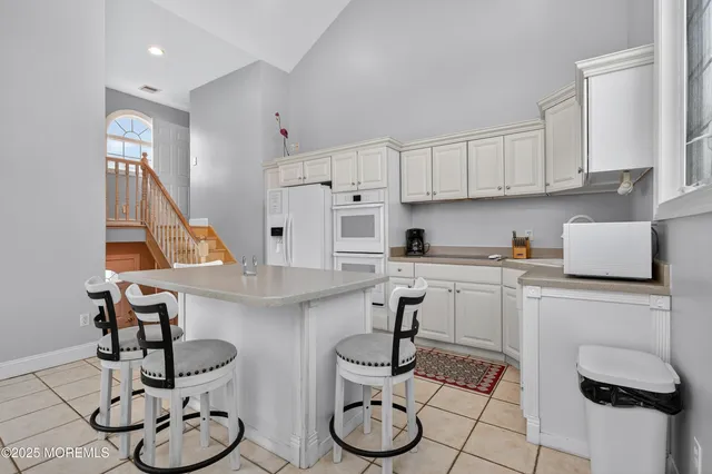 a kitchen with stainless steel appliances granite countertop a sink and cabinets