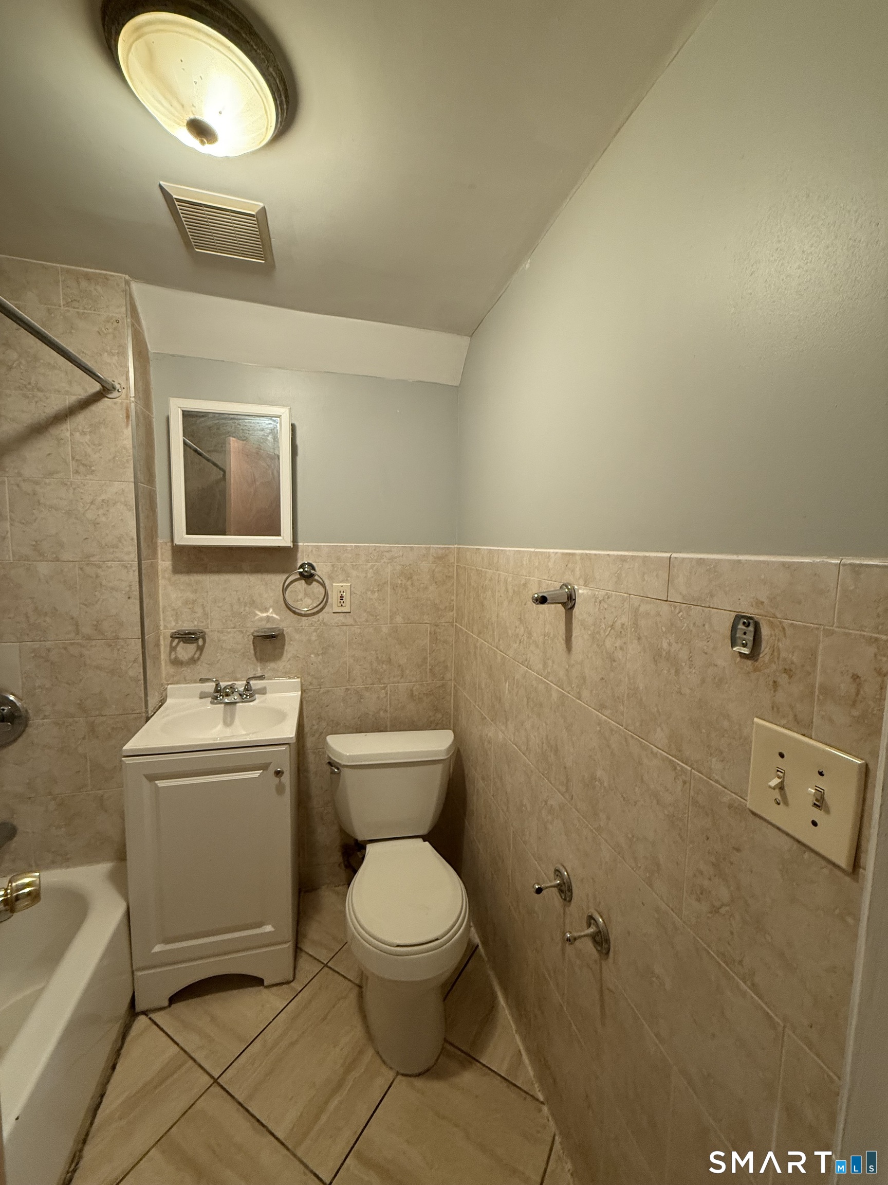 21 North Walnut Street, Unit 3 Waterbury, CT 06704 - Photo 3 of 8 a bathroom with a toilet a sink and mirror