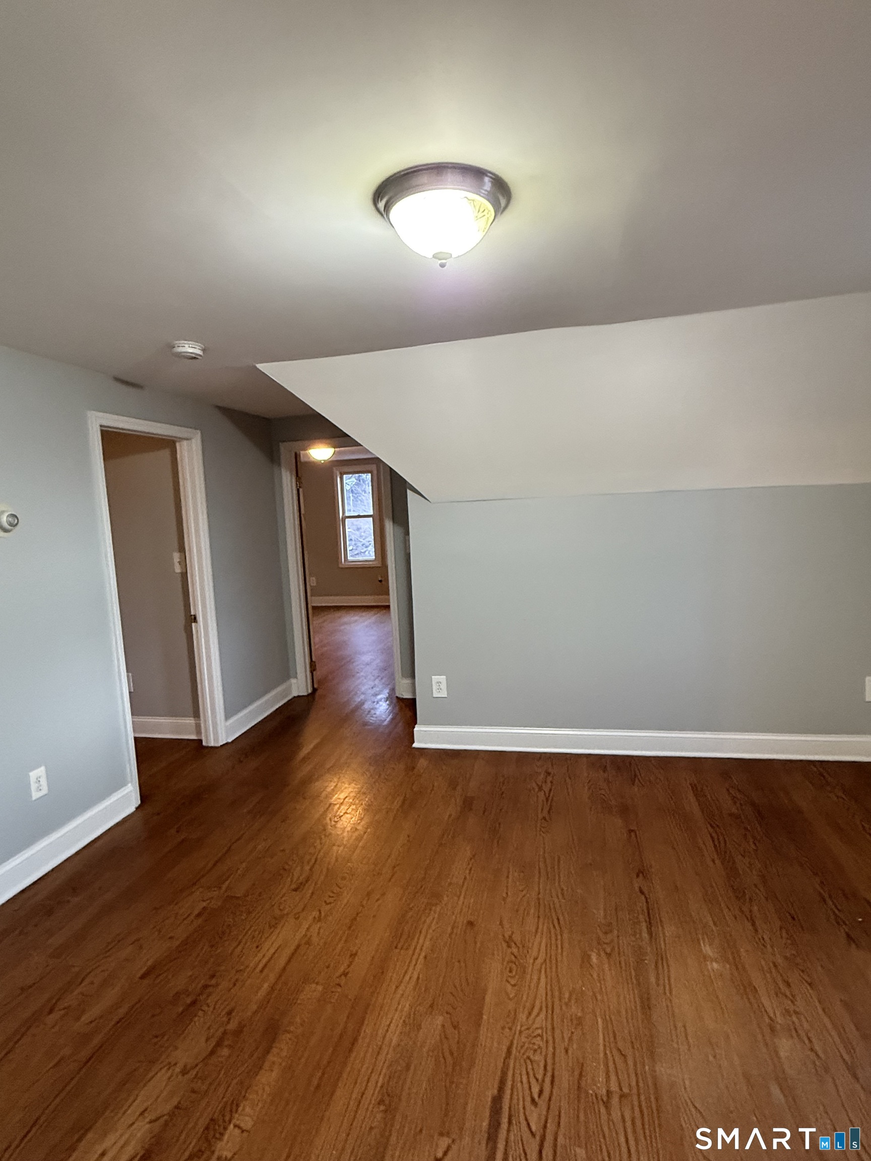 21 North Walnut Street, Unit 3 Waterbury, CT 06704 - Photo 8 of 8 a view of an empty room with wooden floor