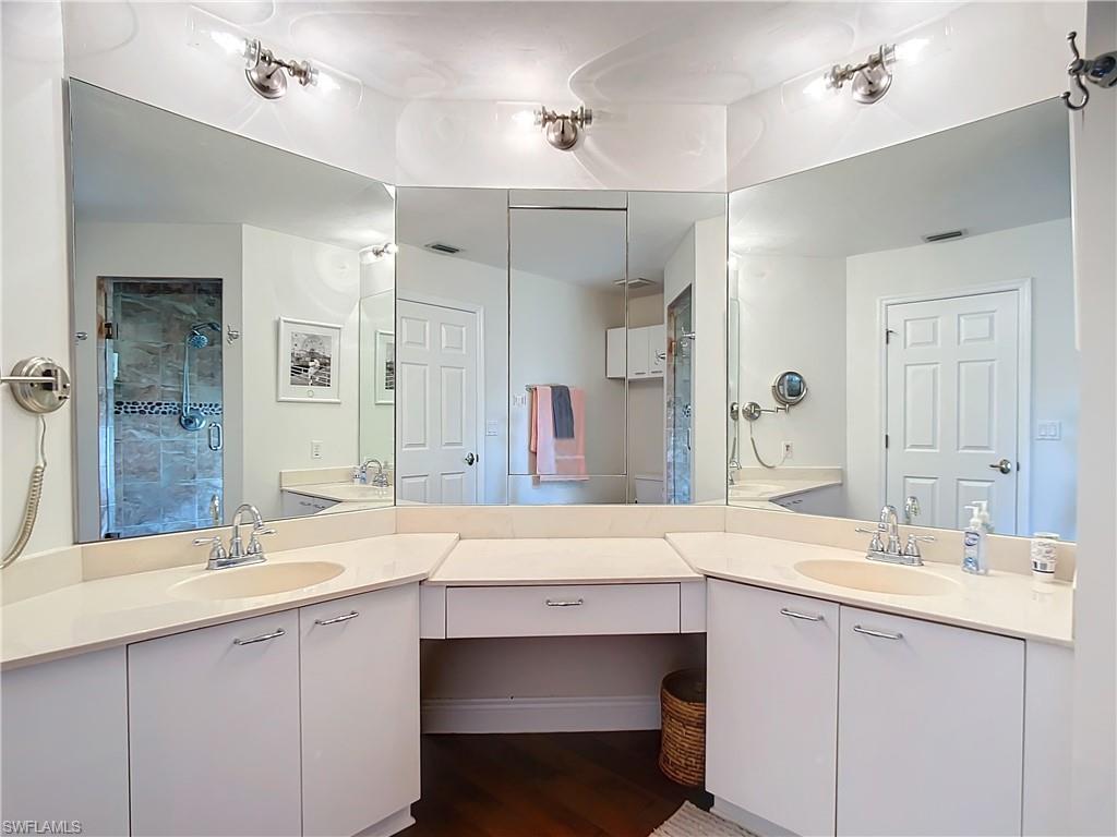 2860 Citrus Lake Drive, Unit R202 Naples, FL 34109 - Photo 36 of 50 a bathroom with a sink double vanity and a mirror