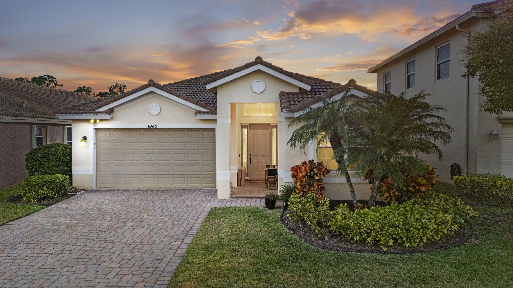 a front view of a house with a garden