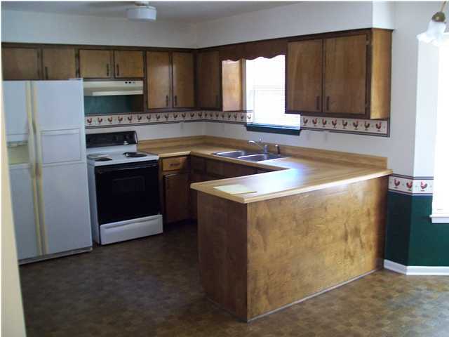 6193 Jonquil Street Crestview, FL 32539 - Photo 3 of 7 a kitchen with stainless steel appliances granite countertop a sink stove and refrigerator