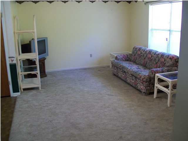 6193 Jonquil Street Crestview, FL 32539 - Photo 4 of 7 a living room with furniture a flat screen tv and windows