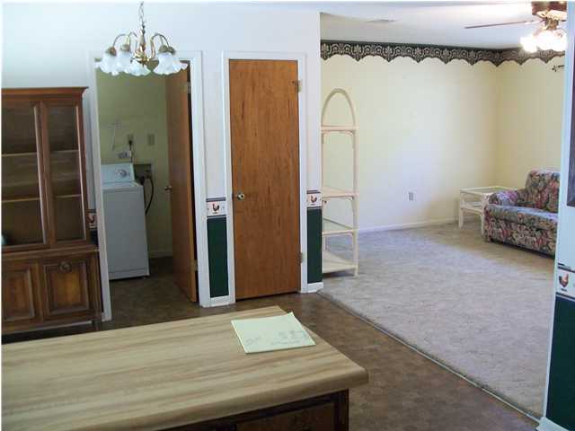 6193 Jonquil Street Crestview, FL 32539 - Photo 5 of 7 a view of a bedroom with wooden floor and a chandelier