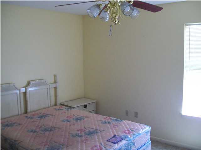 6193 Jonquil Street Crestview, FL 32539 - Photo 6 of 7 a bedroom with a bed and a window