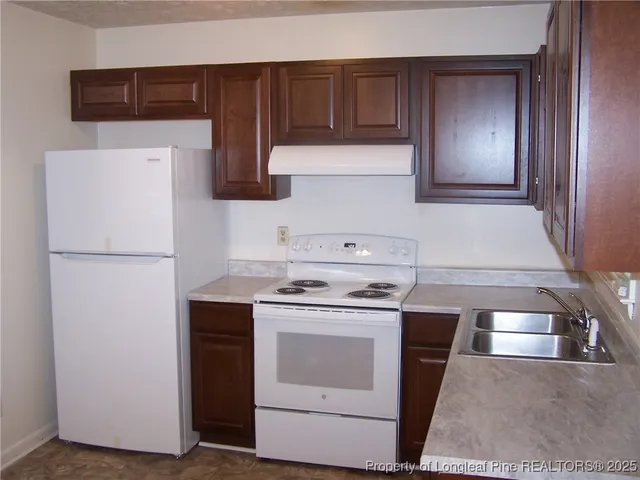 a kitchen with a stove and a refrigerator