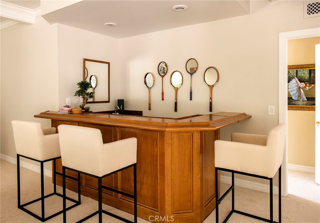 29528 Ridgeway Drive Agoura Hills, CA 91301 - Photo 15 of 41 a table with chairs and white cabinet with wooden floor
