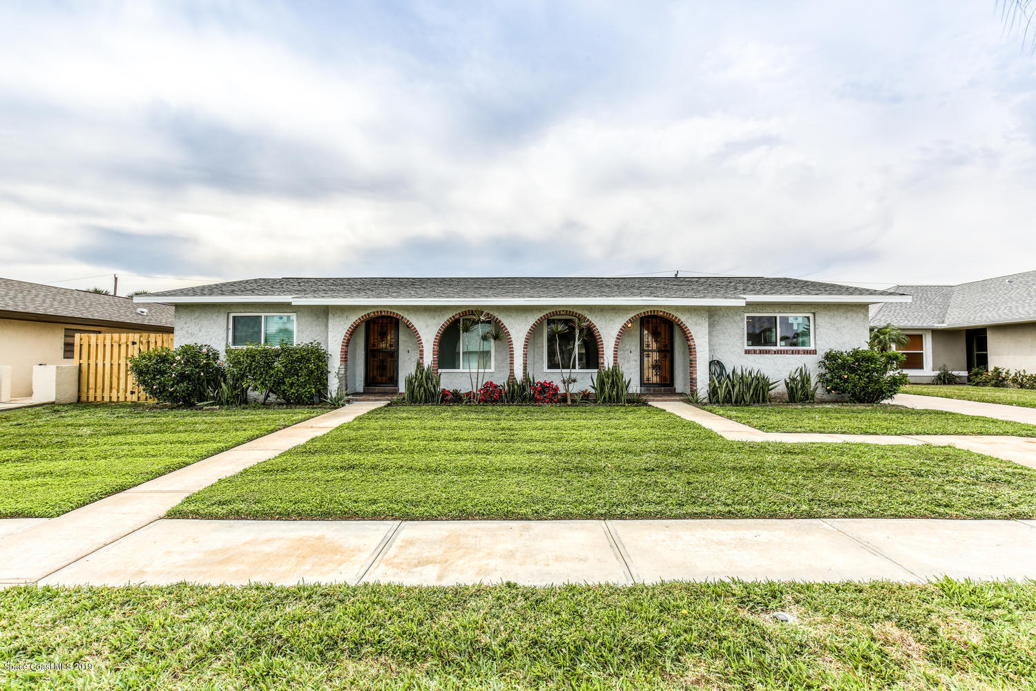 a front view of a house with garden