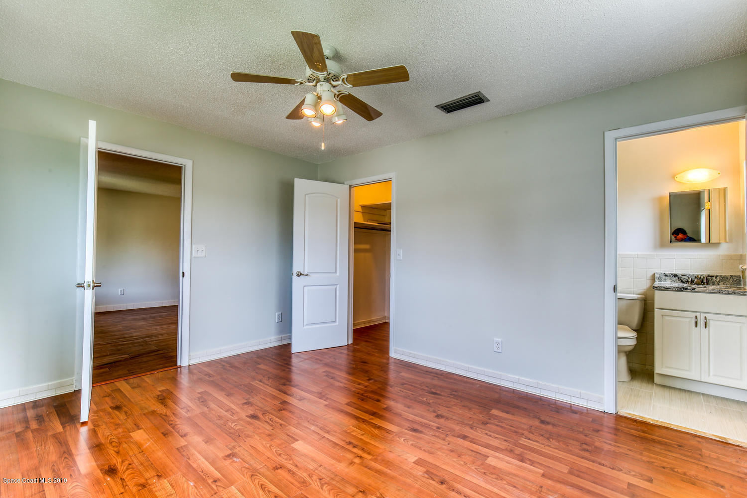 201 Ocean View Lane Melbourne, FL 32903 - Photo 11 of 21 a view of a kitchen with wooden floor and a ceiling fan