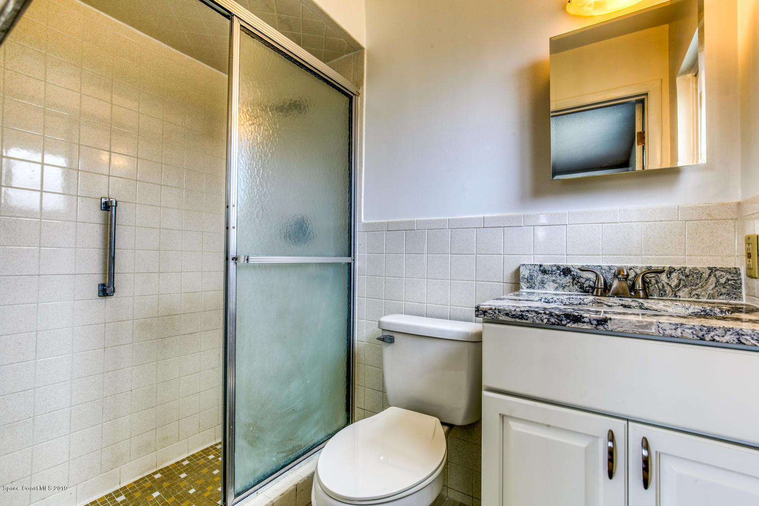 201 Ocean View Lane Melbourne, FL 32903 - Photo 13 of 21 a bathroom with a toilet sink and mirror