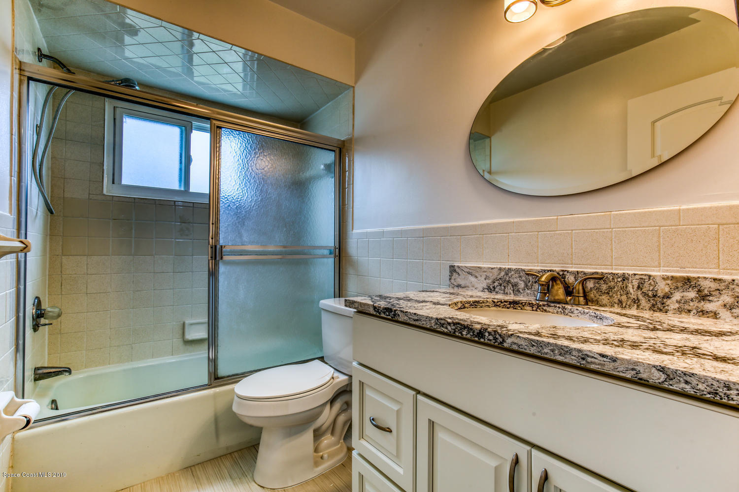 201 Ocean View Lane Melbourne, FL 32903 - Photo 15 of 21 a bathroom with a granite countertop sink toilet and shower