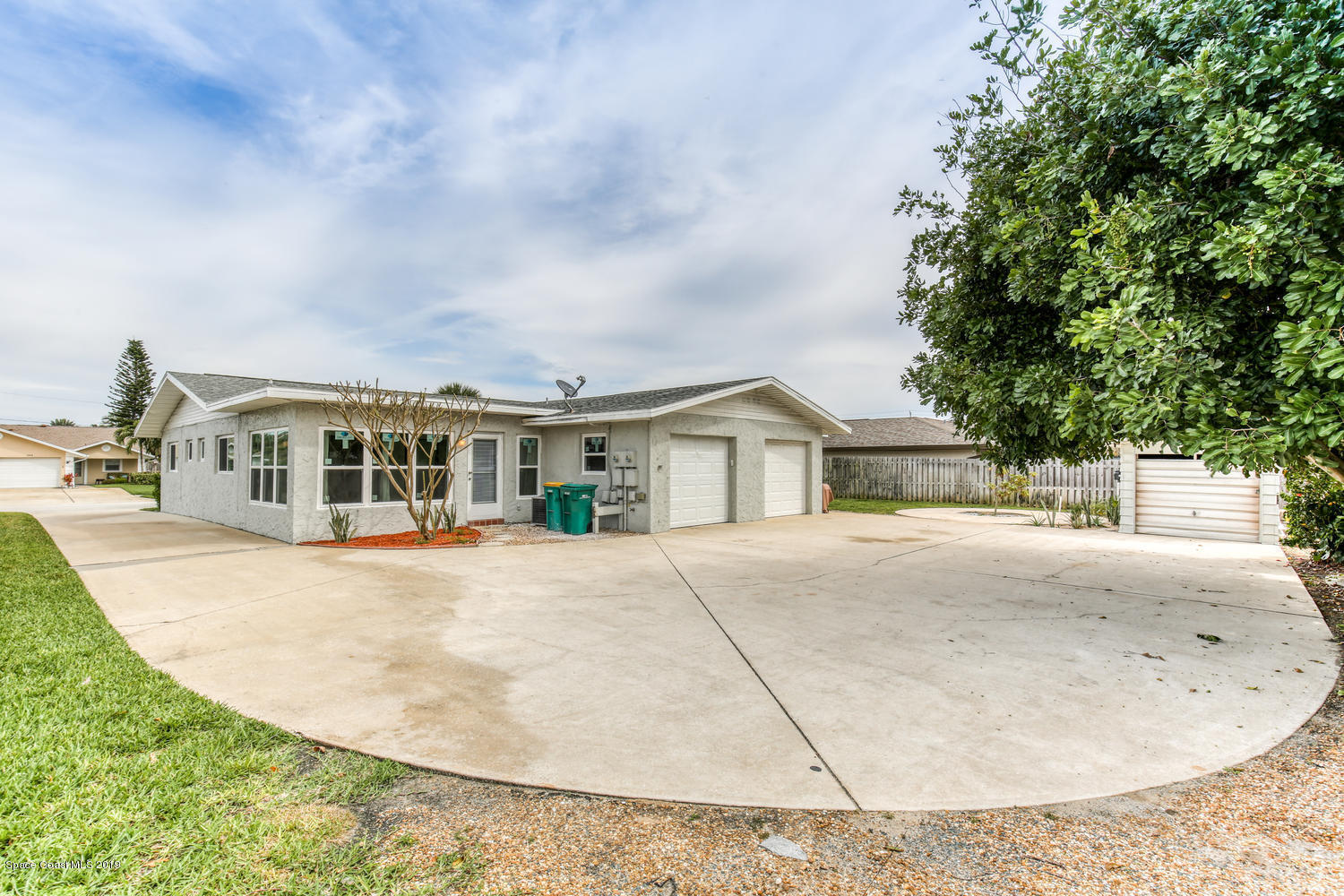 201 Ocean View Lane Melbourne, FL 32903 - Photo 18 of 21 a front view of a house with yard and trees in the background